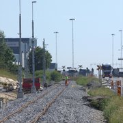 Ny ballast, oriktat spår och kontaktledningsstolpar med belysning längs S. Stillerydsvägen.